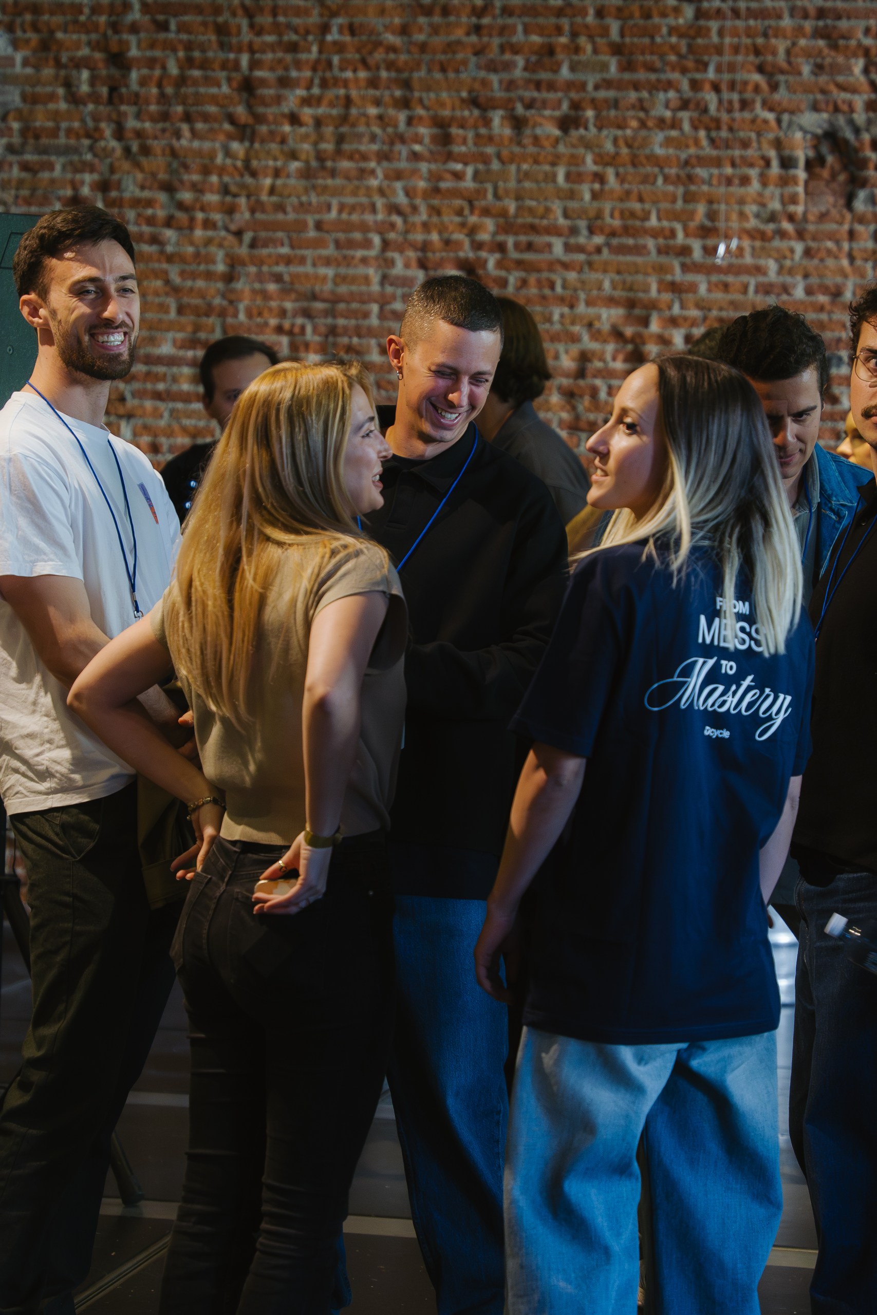 Dcycle team networking at Ahead Madrid, wearing From Mess to Mastery t-shirts