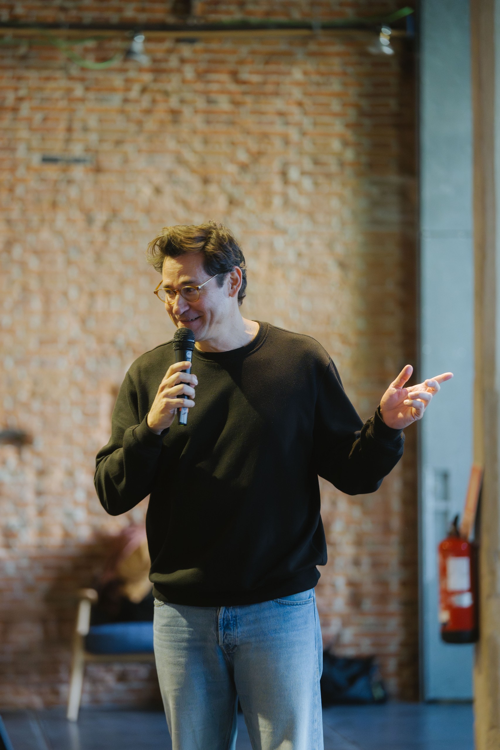 Diego from Tailor speaking on stage at Ahead Madrid 2026 with brick wall background